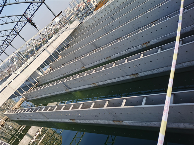 Rows of stainless steel water collection troughs above a treatment basin